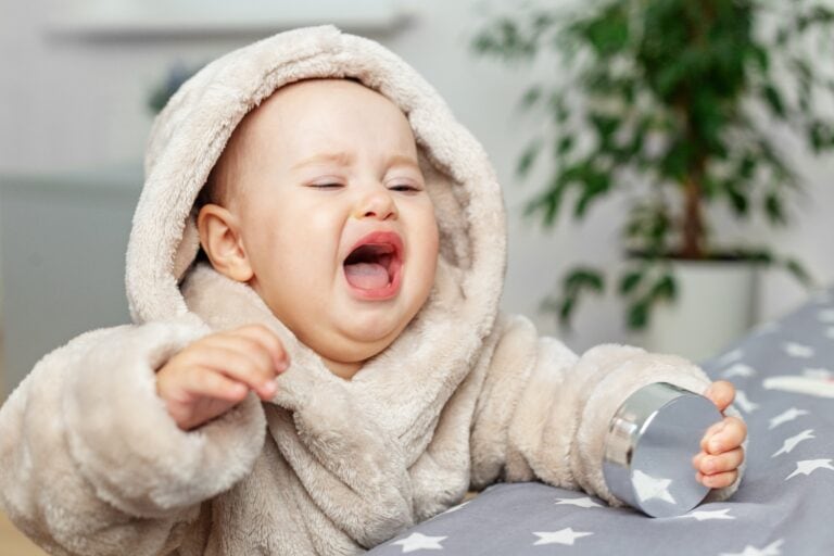 Upset,Baby,Wearing,A,Fluffy,Hooded,Robe,Cries,While,Standing